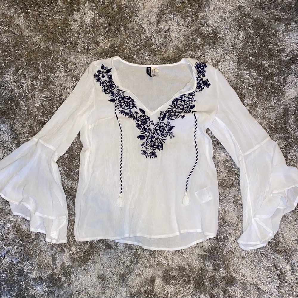 White blouse with blue detailing and flare arms